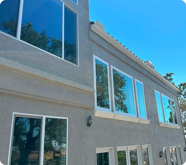 Exterior view of two-story home with newly installed energy-efficient windows