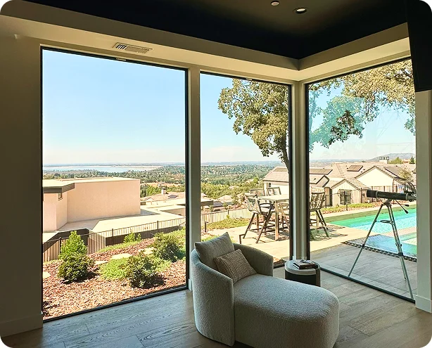 Modern home interior with panoramic floor-to-ceiling windows and outdoor view