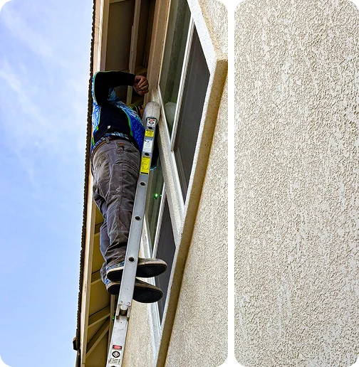 Professional exterior window cleaning using ladder on residential home